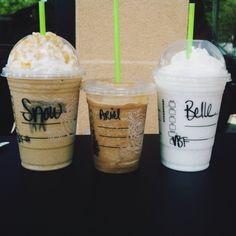 three different types of drinks sitting on top of a black table next to each other