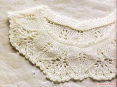 a white crocheted doily on top of a bed