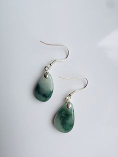 A pair of real green&white jade teardrop earrings with 925 Sterling Silver hook. The simple and delicate teardrop earrins are carved from Grade-A quality green icy jade. The jade color is all-natural and genuine, clear jade texture can be easily observed under the daylight. Some highlights of this pair of minimalistic jade earrings: *High quality guaranteed. Grade-A natural green jade, handmade with 925 sterling silver. *Graceful and simple teardrop design *Each teardrop is measured around 1 Elegant Teardrop Jade Jewelry, Handmade Teardrop Jade Jewelry, Elegant Teardrop Jade Earrings, Handmade Jade Teardrop Earrings, Green Jade Teardrop Pendant Jewelry, Real Green, Jade Color, Jade Earrings, White Jade