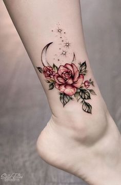 a woman's foot with flowers and a crescent tattoo on the left side of her leg