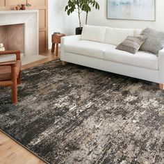 a living room with a couch, chair and rug