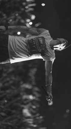 a man flying through the air while riding on top of a water skiboard in front of trees