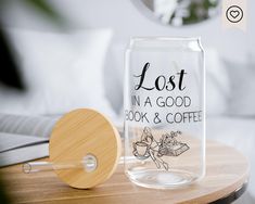 a glass jar with the words lost in a good book and coffee sitting on a table