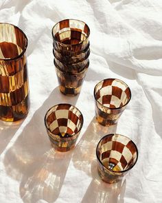 several brown and white checkered glass cups