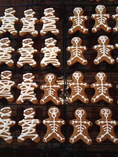 several rows of decorated ginger cookies with white icing on the top, and bottom