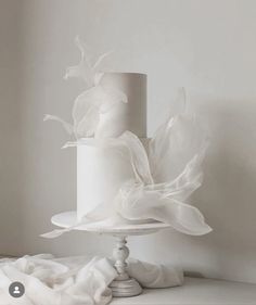 a white wedding cake sitting on top of a table