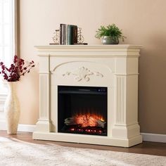 a white fireplace in a living room next to a vase with flowers