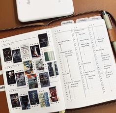 an open planner with pictures and text on it next to a laptop computer, pen and phone