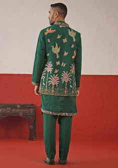 Elevate your style with Green Embroidered Kurta Set With Jacket. Made from luxurious georgette, this set exudes elegance. The jacket showcases intricate resham and sequinned embroidery, while the kurta features meticulous detailing and all-over motifs. Completed with a beautifully embroidered dupatta and matching pants. Perfect for Sangeet, Mehendi, or as a wedding guest outfit. Composition : Jacket, Kurta, Trouser & Dupatta : Viscose Georgette Care: Dry Clean Only and Vacuum Storage This produc Designer Silk Fitted Outerwear, Fitted Silk Outerwear, Green Embroidered Chanderi Bandhgala, Formal Chanderi Bandhgala With Chikankari Embroidery, Silk Long Sleeve Sherwani For Navratri, Formal Nehru Jacket With Floral Embroidery And Straight Cut, Formal Nehru Jacket With Floral Embroidery And Straight Fit, Formal Straight Nehru Jacket With Floral Embroidery, Festive Nehru Jacket With Floral Embroidery Traditional Drape