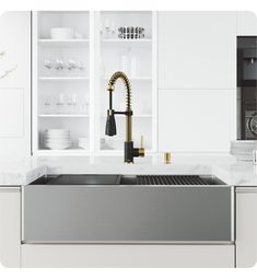 a kitchen with white cabinets and stainless steel sink in front of an open shelf filled with dishes