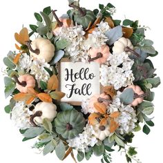 a wreath with white flowers and pumpkins on it that says hello fall in the center