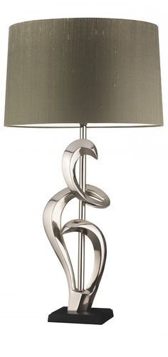 a lamp that is sitting on top of a table next to a lamp shade in the shape of a spiral