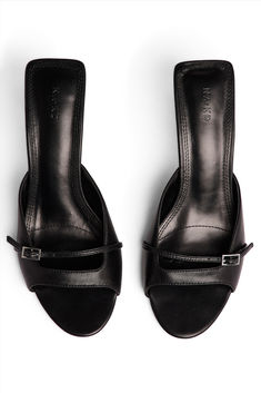 Buckle Detail Mules Classic Mules With 4-inch Heel, Black Kitten Heels With Buckle Closure For Spring, Office Mules With Heel Strap And Open Heel, Office Wear Open Heel Mules With Heel Strap, Classic Pointed Toe Mules With Buckle Closure, Formal Mules With Buckle Closure And Open Heel, Black Kitten Heels With Buckle Closure, Classic Evening Mules With Buckle Closure, Black Pointed Toe Mules With Buckle Closure