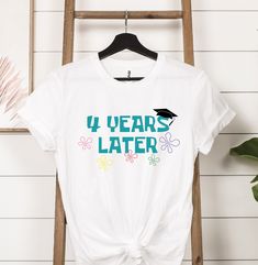 4 Years Later Graduate Shirt, Graduate Shirt, Kids Graduation Shirt, Graduation Shirt, Senior Shirt, Class of 2023 Shirt, Pre-k Grad Shirt HOW TO PLACE YOUR ORDER * Choose your t-shirt color * Choose your size * Choose your design & text color * PLEASE make sure all your order's steps PRODUCT DESCRIPTION T-shirt feels soft and light, with just the right amount of stretch. It's comfortable and the unisex cut is flattering for both men and women. * Solid colors are 100% combed and ring-spun cotton * Ash color is 99% combed and ring-spun cotton, 1% polyester * Heather colors are 52% combed and ring-spun cotton, 48% polyester * Athletic and Black Heather are 90% combed and ring-spun cotton, 10% polyester * Heather Prism colors are 99% combed and ring-spun cotton, 1% polyester * Fabric weight: Graduation Vacation Shirt, Senior Class Tshirts 2023, Grad T Shirt Ideas, White Pre-shrunk Tops For Graduation, White Pre-shrunk Top For Graduation, Short Sleeve Birthday Shirt For End Of School Year, White Cotton Shirt For Graduation, Casual Cotton Tops For Graduation, White Casual Tops For Graduation