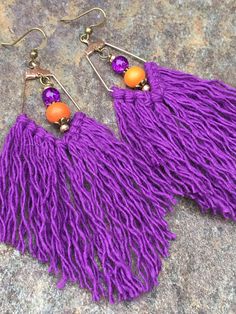 purple tassel, lightweight, perfect everyday earrings. They are made with gold (nickel free) fishhook ear wires, czech glass turquoise gold seed beads, orange wood beads, & purple crackle glass beads. Measures 4 inches from the top of the ear wire to the bottom. Translucent, soft rubber earring backs are included. Please take a few moments to browse through my shop. I have a large selection of unique belt buckles, leather belt straps, jewelry, beaded key chains, and other unique items. Order Purple Dangle Tassel Jewelry, Purple Dangle Jewelry With Tassels, Purple Dangle Tassel Earrings With Fringe, Purple Fringe Tassel Earrings Gift, Bohemian Purple Tassel Earrings, Purple Dangle Tassel Earrings, Bohemian Purple Dangle Tassel Earrings, Purple Dangle Earrings With Tassels, Adjustable Purple Bohemian Tassel Earrings