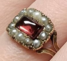 This is a Beautiful Antique Georgian 18k Yellow Gold Garnet and Pearl Ring. It is from the late 1700s.  it is in excellent condition, especially considering it's age. There is an East-west Garnet set in the center of the ring surrounded by lovely pearls. I have had this ring checked and all stones are secure and in place. These pieces are becoming more and more rare and at the same time gaining popularity! it is a size 7.75 and is sizable by a good jeweler who knows about antique jewelry. It is Garnet And Pearl, Georgian Ring, Georgian Jewelry, Garnet Ring, Lovely Ring, Vintage Jewels, Garnet Rings, East West, Multi Stone Ring