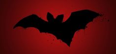 the silhouette of a bat against a red background