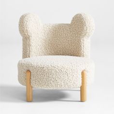 a chair made out of sheep's wool with wooden legs