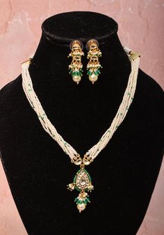 Ahmedabad, Gujarat is well known for its fine Kundan Jewelry art that has been practiced for centuries. Inspired by Royal designs, with a dash of contemporary this set with white multi strand white beads befits a queen! The central Drop pendant with dangling Beads and earrings are prominent and charming  Note: This jewelry has no precious metals or stones. Note: Some pics are close up shots to show detail and may make the product appear larger. For a more accurate perspective on size, please check the measurements picture. Luxury Handmade Kundan Temple Necklace, Luxury Kundan Meenakari Temple Necklace, Luxury Handmade Kundan Temple Jewelry Necklace, Traditional White Polished Beads Jewelry, Festive White Kundan Necklace With Polished Beads, Traditional White Kundan Necklace With Polished Beads, White Kundan Fusion Necklace, White Fusion Style Kundan Necklace, Handmade White Kundan Beaded Necklace