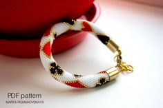 a red and white bracelet sitting on top of a table