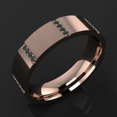 a rose gold wedding ring with blue diamonds on the inside and inlays to the outside