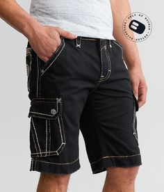 Rock Revival Classic Cargo Short - Black 42/12 Inseam, Men's Black Slim fit short 12 rise 12 inseam Embroidery on pieced back pockets Grinding details Zip fly. 100% Cotton. Machine wash separately in cold water inside out. Do not bleach. Tumble dry low. Remove promptly. Warm iron if needed.. MEN'S ROCK REVIVAL SHORT SIZE CONVERSION CHART Size 27 28 29 30 31 32 33 34 36 38 40 42 44 Waist 29 30 31 32 33 34 35 36 38 40 42 44 46 *Conversion sizes may vary. Measurements based on size 32. Apparel & Ac Rock Revival Shorts, Cargo Short, Cargo Shorts Men, Conversion Chart, Slim Fit Shorts, Rock Revival, Men's Shorts, Mens Suits, Cargo Shorts