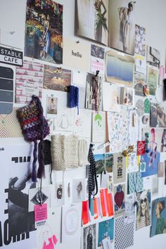 a wall covered in pictures and magnets next to a white wall with many different things on it