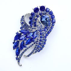 Elegant and stunning rhinestone blue brooch rhinestone embellishment, which can be used for your DIY project - blue wedding bridal brooch bouquet, bridal or prom gown sash, necklace, ring pillow, cake and frame decorations, event decor, crafts, scrap booking and much more.  Size: 3 1/2 inch high 2 inches wide Metal: Silver plated This crystal royal blue broach can be ordered with pin in the back to add to wedding gown or dress sash, to wire into brooch bouquet, or any number of other craft projects; or without the pin as a flat back embellishment for your sew-on, glue-on DIY project. More ROYAL BLUE brooches - https://www.etsy.com/shop/Crystalitzy?section_id=16200394&ref=shopsection_leftnav_4 Please note that this crystal rhinestone embellishment has flat backing, it is suitable only for y Diy Wedding Dress Sash, Mertensia Virginica, Brooches Diy, Pillow Cake, Sapphire Blue Weddings, Blue Brooch, Bridal Brooch, Blue Sapphire Jewelry, Bridal Brooch Bouquet