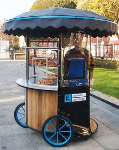 an old fashioned ice cream cart on the sidewalk