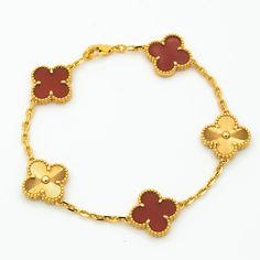 This charming Clover Bracelet showcases 5 stunning motifs in Carnelian Gold. The delicate design exudes elegance and sophistication, making it the perfect accessory for any occasion. Show off your style with this unique and versatile bracelet that effortlessly elevates any outfit. ADDITIONAL INFORMATION Color: Gold Stone:no Ref. H1213121 Material:- 925 Sterling Silver - 18k Gold Plated- 18k Real Gold ( contact us via instagram) Bracelet wrist size: 19 cm Our replica products are committed to qua Cheap Elegant Yellow Gold Charm Bracelet, Yellow Gold Elegant Bracelets, Luxury Red Gold Bracelet For Formal Occasions, Luxury Red Gold Bracelet For Formal Events, Luxury Gold Plated Bracelet Gift, Yellow Gold Plated Bracelet Gift, Yellow Gold Plated Bracelet For Gift, Exquisite 14k Gold Bracelet, Elegant Red Bangle Gold Bracelet