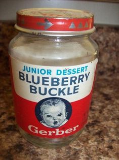 a glass jar filled with blueberry buckle sitting on top of a counter