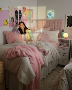 a woman sitting on top of a bed in a bedroom