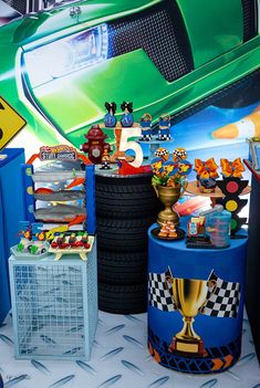 a car themed birthday party with cars and race tires on the floor, including toys