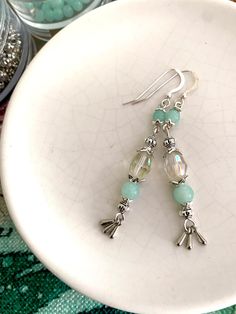 Aqumarine and silver, these dainty handcrafted earrings can be customised with your choice from the four gorgeous styles.  Created with bohemian vibes these are a one of a kind artisan made accessory. With amazing light blue glass, solid sterling silver ear wires combined with high-quality nickel free silver beads and charms, these earrings are perfect for special occasion or everyday wear. These beauties will shine as sister or bridesmaid gifts for 2,3 or 4 special people and are the perfect ad Silver Aquamarine Dangle Earrings, Aquamarine Dangle Earrings With Ear Wire, Handmade Aquamarine Dangle Earrings, Handmade Aquamarine Drop Earrings, Bohemian Vibes, Aquamarine Gemstone, Handcrafted Earrings, Special People, Vintage Crystal