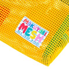 a yellow mesh bag with a sticker on it