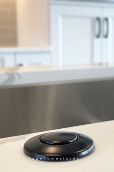 close up image of matte black disposal button installed in white marble look quartz countertop Garbage Disposal Button, Calacatta Laza Quartz, Calacatta Laza, Black Kitchen Design, Kitchen Garbage, Island Counter, Matte Black Kitchen