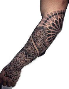 a man's arm with an intricate tattoo design on it