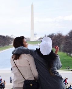 two women standing in front of the washington monument