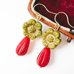 Festive Green and Red Big Flower Earrings for the Holiday Season. Make a statement this holiday season with these bold green and red flower earrings, designed to add a festive touch to any outfit. Perfect for holiday parties and gatherings, these vibrant large floral earrings bring a fun and whimsical flair to your look. Their eye-catching design makes them an ideal accessory for anyone looking to embrace the holiday spirit in style. Lightweight and comfortable, they're perfect for all-day wear during the holiday festivities. Key Features: 1.5" long 24K gold plated ear wires Bold floral design in festive green and red 12mm Green flowers Perfect for holiday parties and special events Lightweight for all-day comfort Adds a fun, whimsical touch to any outfit handmade in VT Shipped in a gift b Festive Red Flower Earrings, Festive Red Flower Drop Earrings, Red Drop Flower Earrings For Festive Occasions, Red Bohemian Earrings For Christmas, Green And Red Christmas, Red Flower Earrings, Holiday Earrings, Holiday Earring, Big Flowers