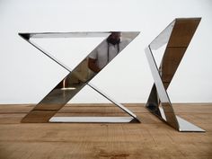 a metal sculpture sitting on top of a wooden floor