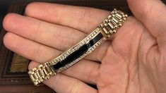 This fine bracelet is accented with black onyx inlay that is bordered with two- rows of nineteen (19), channel set, round brilliant cut diamonds. The bracelet measures 11.3mm wide and an overall length of 7-1/2 inches. The bracelet is finished with a hidden box clasp and figure eight safety. Luxury Channel Set Diamond Bracelet, Luxury Black Bracelets, Luxury Tennis Bracelet With Channel Set For Formal Occasions, Black 14k Gold Bracelet For Formal Occasions, Luxury Black Enamel Jewelry For Formal Occasions, Luxury Channel Set Tennis Bracelet For Formal Occasions, Luxury Black Jewelry For Formal Occasions, Luxury Black Bracelet Jewelry, Timeless Black Bracelet Jewelry