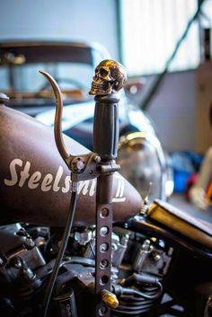 a motorcycle with a skull on the handlebars and a wrench attached to it