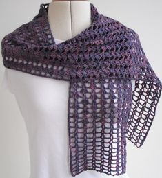 a purple crocheted shawl on a mannequin