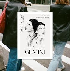 two women walking down the street holding up a poster that says gemini on it