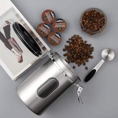 the coffee grinder is next to some beans and other items for making coffees