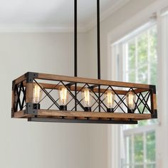 a wooden light fixture hanging from a ceiling