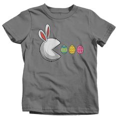 Kids Funny Easter Shirt Easter Bunny Eggs T Shirt Egg Hunter Tshirt Rabbit Graphic Tee Streetwear Boy's Girl's Youth Toddler This funny t shirt is perfect for Easter! It features an Easter bunny with open mouth hunting after those coveted eggs. A great fun piece of streetwear that your nieces and nephews or students will get a kick out of! Get eggcited in a custom tee printed just for you. Made of soft, ring spun cotton. Includes a drawstring cotton gift bag. Direct to garment printed using the Graphic Tee Streetwear, Rabbit Graphic, Funny Easter Shirt, Bunny Eggs, Idee Cricut, Easter Bunny Eggs, Funny Easter, Easter T Shirts, Cotton Gift