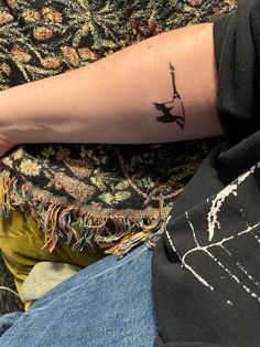 a person's arm with a tattoo on it and a bird sitting on top of the arm