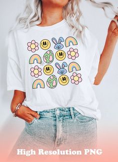 a woman with blonde hair wearing a white t - shirt that has smiley faces and rainbows on it