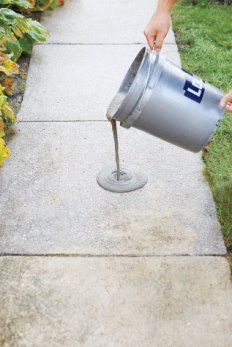 a person pouring water into a bucket on top of a cement sidewalk with the words how to resurface worm concrete